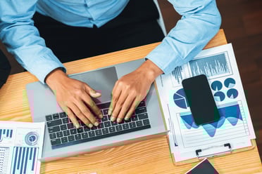 top-view-diverse-group-business-analyst-team-analyzing-financial-data-report-paper-meeting-table-chart-graph-dashboard-by-business-intelligence-analysis-meticulous